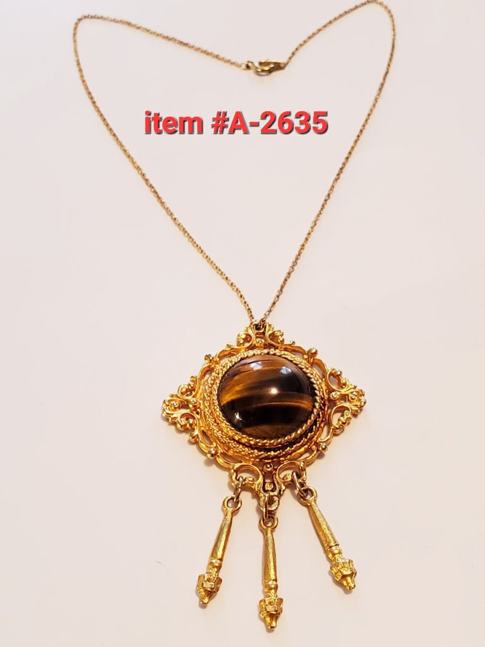 1 Gold Necklace with pendant, item # A 2635,. wt . 27 grams.
